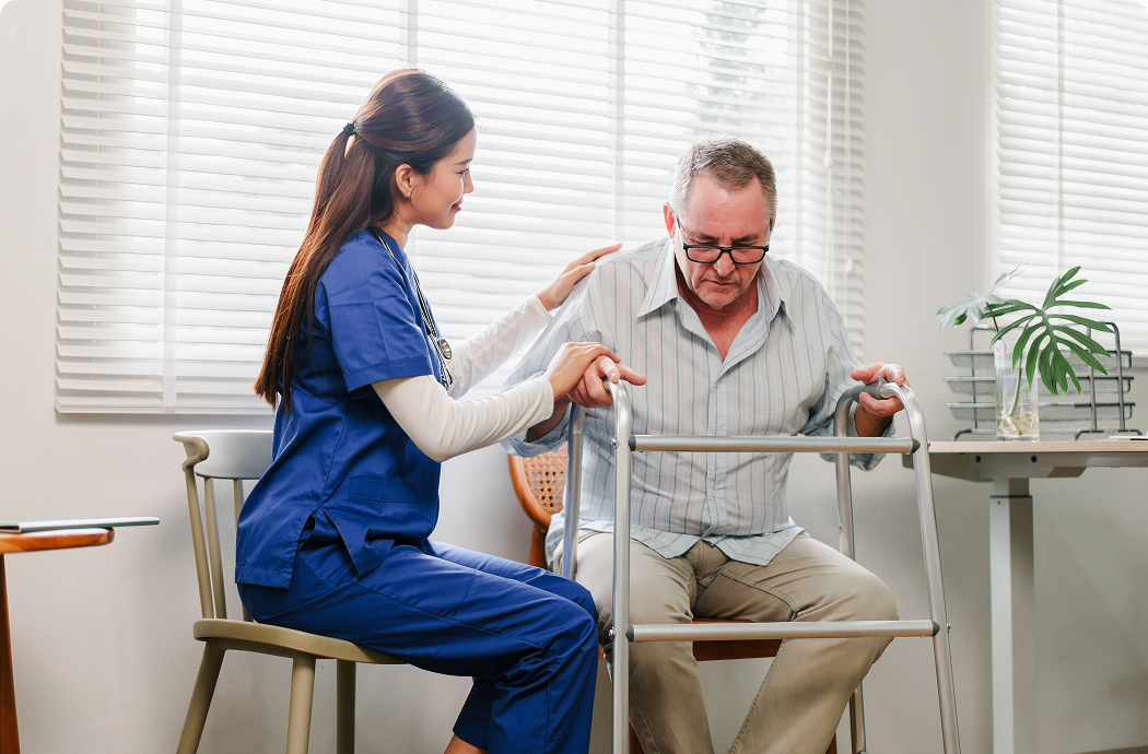 A man using a walking frame with a nurse